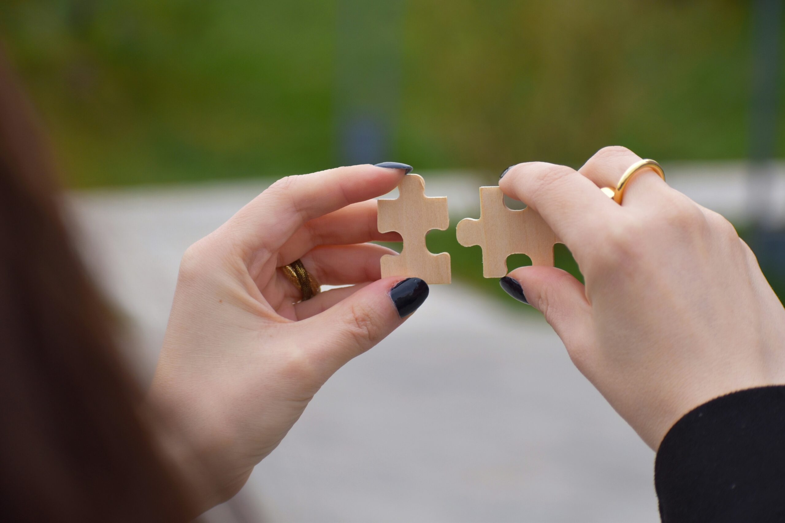 Two people holding a small object together between their hands